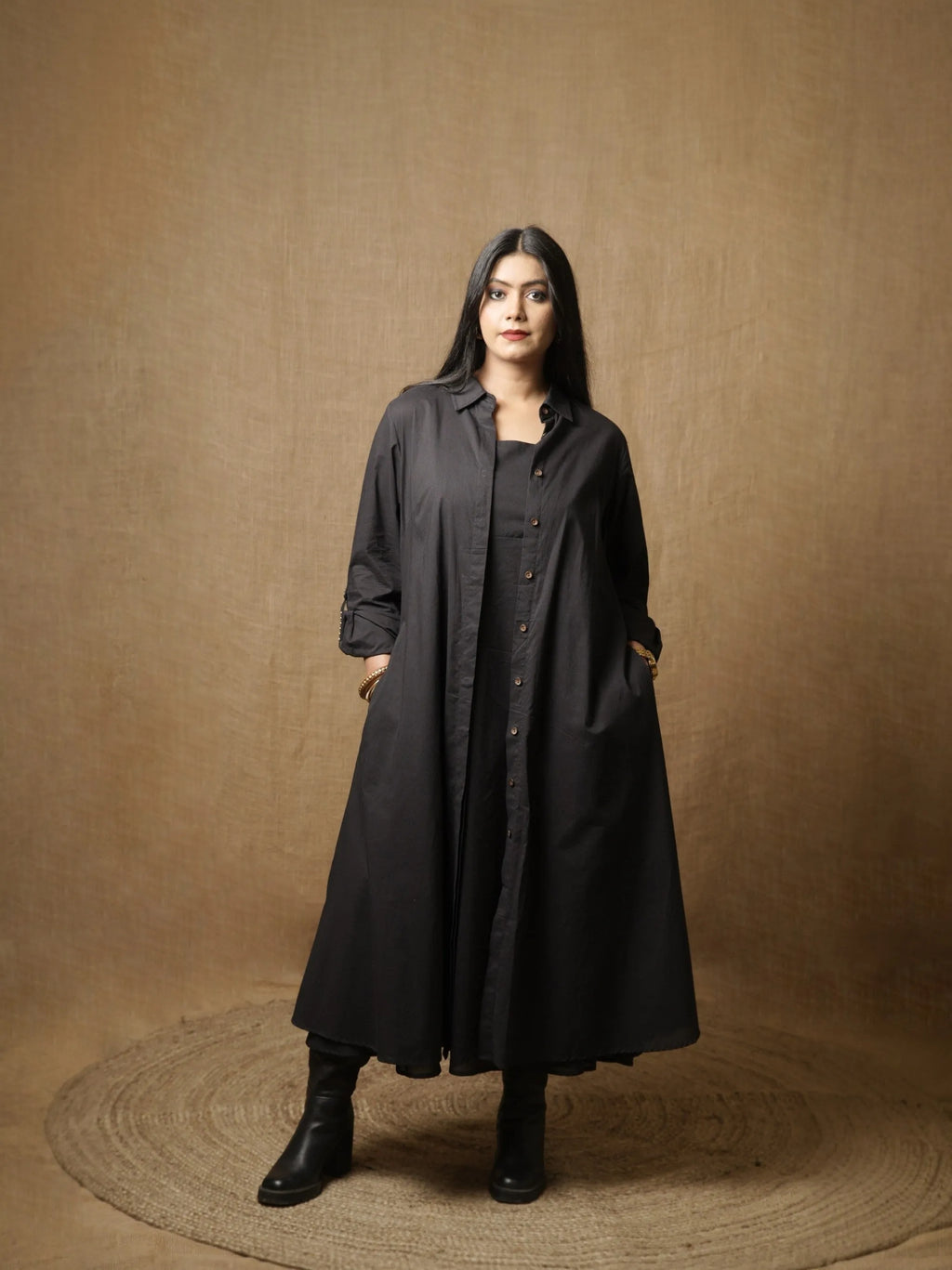 Black A-line shirt dress with button placket and long sleeves, front view